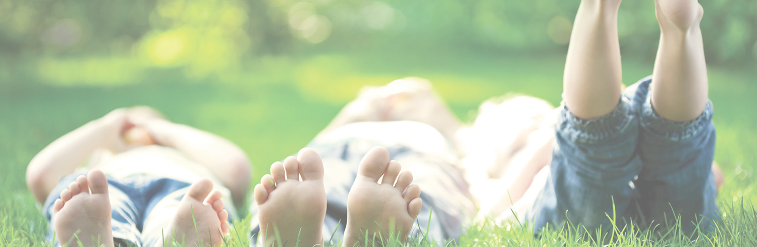 children laying on grass