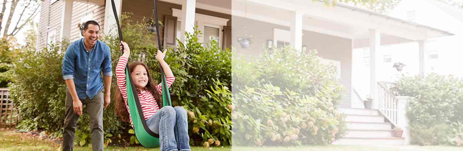 father pushing daughter in swing